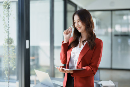 business owner or Asian female marketers are using tablet computer in office work.の写真素材