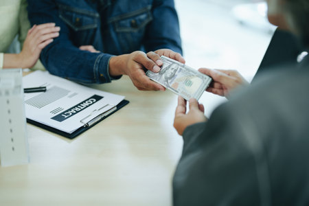 The banks credit officer released the loan after a male business owner entered into an insurance contract using the mortgaged home property.の写真素材