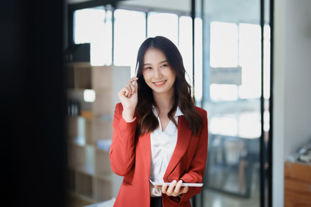 business owner or Asian female marketers are using tablet computer in office work.の写真素材