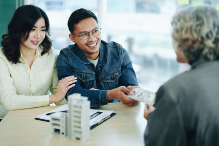 The banks credit officer released the loan after a male business owner entered into an insurance contract using the mortgaged home property.の写真素材