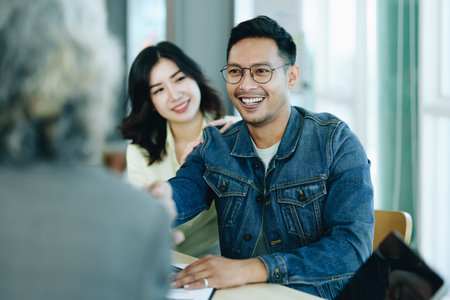 The banks credit officer released the loan after a male business owner entered into an insurance contract using the mortgaged home property.の写真素材