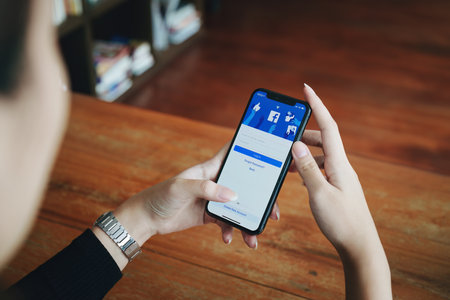 Chiang Mai Thailand. JUN 29, 2022. Woman holds smart phone with facebook application on the screen. facebook is a photo-sharing app for smartphones.のeditorial素材