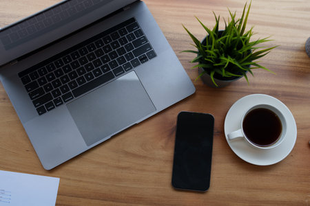 Computers and mobile phones are placed at the desk during lunch breaks.の写真素材