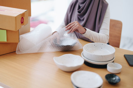 Beautiful Muslim woman selling online at home, business owner, business sme concepts.の写真素材