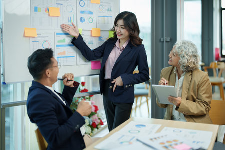 Asian entrepreneurs and business people meeting in a conference room in business planning, financial budget and investment risk assessment to analyze customer groups to increase company growth.の写真素材