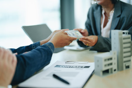 The banks credit officer released the loan after a male business owner entered into an insurance contract using the mortgaged home property.の写真素材
