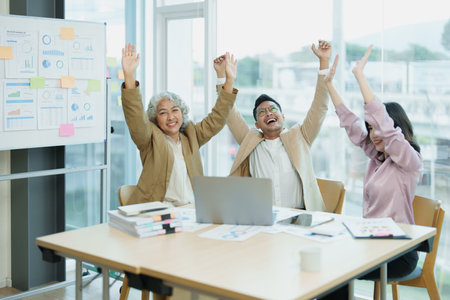 Entrepreneurs and a group of Asian entrepreneurs are delighted to be successful in marketing planning. Successfully exceeded the target set. Received bonuses and good salary.の写真素材