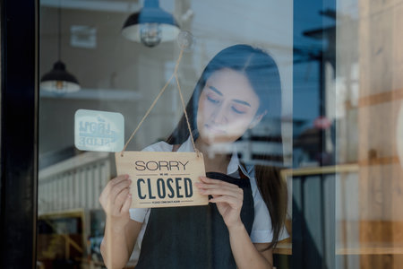 Startup successful sme small business owner. Pretty girl standing in front of store holding sign...
