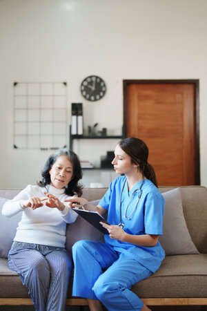 Portrait of a female doctor holding a patient clipboard to discuss and analyze wrist and finger painの写真素材