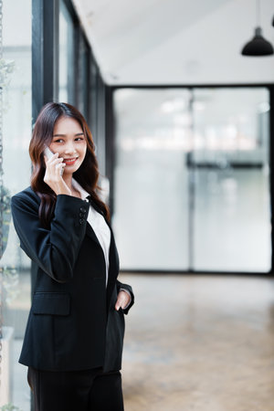 business owner or Asian female marketers are using business phones in office work.の写真素材