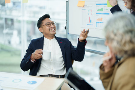 Asian entrepreneurs and business people meeting in a conference room in business planning, financial budget and investment risk assessment to analyze customer groups to increase company growth.の写真素材