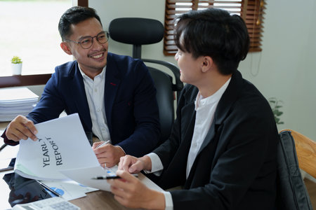 Teamwork concept, consultation, male economist using documents budget, finance and investment documents, discussing and planning finances with female advisors in conference room.の写真素材