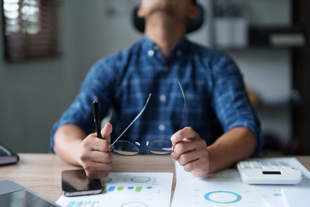 Portrait of sme business owner, man using computer and financial statements Anxious expression on expanding the market to increase the ability to invest in business.の写真素材
