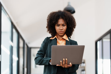 Beautiful young teen American African business woman thoughtful confused looking at laptop computer, Stress while reading report or email. Online marketing problem, finance mistake, troubleshooting.の写真素材