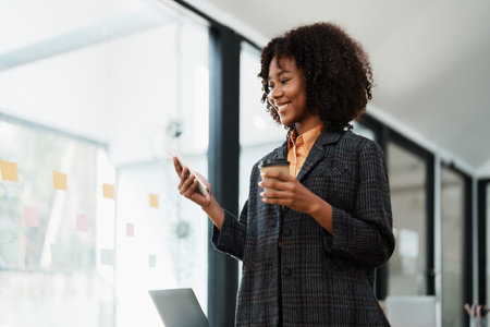 Beautiful young teen American African working on smartphone mobile with in do document, tax, exchange, accounting and Financial advisor.の写真素材