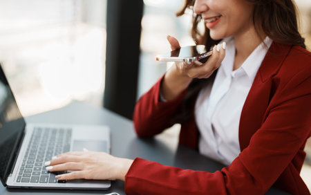Beautiful young teen asian businesswoman using computer and smartphone mobile with planning working on financial document, tax, exchange, accounting and Financial advisor.の写真素材