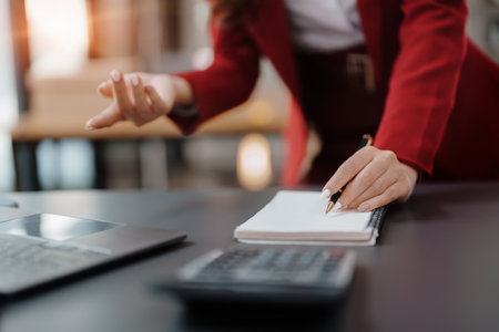 Beautiful young teen asian business woman meeting at on computer laptop with planning working on financial document, tax, exchange, accounting and Financial advisor.の写真素材