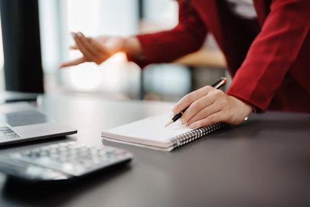 Beautiful young teen asian business woman meeting at on computer laptop with planning working on financial document, tax, exchange, accounting and Financial advisor.の写真素材