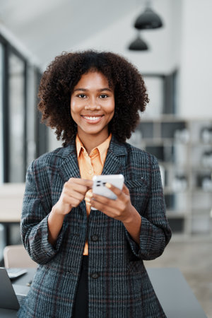 Beautiful young teen American African working on smartphone mobile with in do document, tax, exchange, accounting and Financial advisor.の写真素材