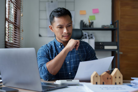 Entrepreneurs, business owners, accountants, real estate agents, A young man using a calculator to...