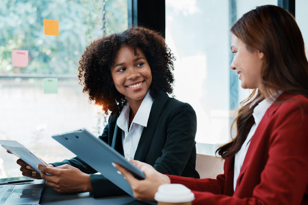 Multiethnic business, Beautiful American African with asian businesswomans people in meeting. Accountant people do document, tax, exchange, accounting and Financial advisor.の写真素材