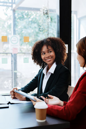 Multiethnic business, Beautiful American African with asian businesswomans people in meeting. Accountant people do document, tax, exchange, accounting and Financial advisor.の写真素材