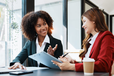 Multiethnic business, Beautiful American African with asian businesswomans people in meeting. Accountant people do document, tax, exchange, accounting and Financial advisor.の写真素材