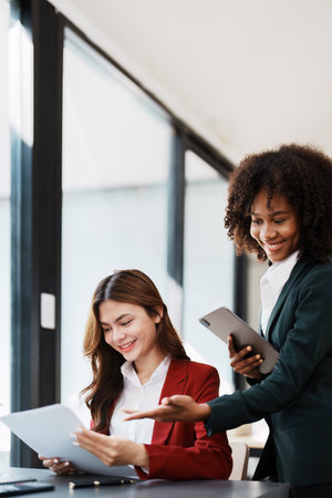 Multiethnic business, Beautiful American African with asian businesswomans people in meeting. Accountant people do document, tax, exchange, accounting and Financial advisor.の写真素材