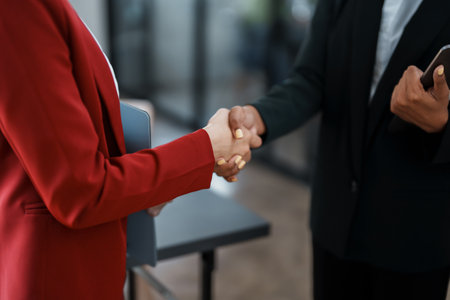 Multi ethnic business Financial shaking hands, Successful businessmen handshaking after good deal. Business Finishing up meeting contract concept.の写真素材