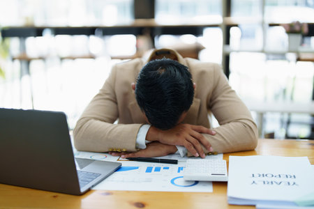 Portrait of sme business owner, man using computer and financial statements Anxious expression on expanding the market to increase the ability to invest in business.の写真素材
