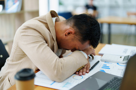 Portrait of sme business owner, man using computer and financial statements Anxious expression on expanding the market to increase the ability to invest in business.の写真素材