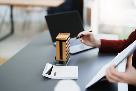portrait of an asian man, Agent, buy and sell land, property tax, show the concept of protecting the house to insure the risk of damage to the home.の写真素材