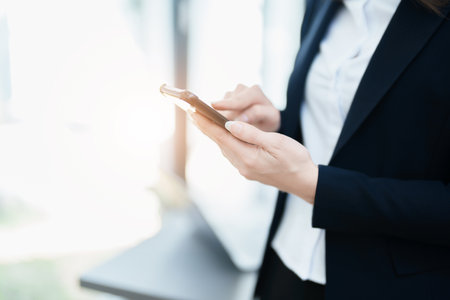 business owner or Asian female marketers are using business phones in office work.の写真素材