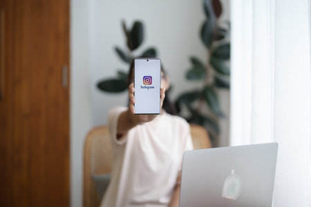 CHIANG MAI, THAILAND - Jul 09, 2022: A woman holds Smart android phone with Instagram application on the screen at cafe.のeditorial素材