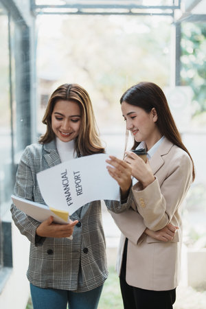 Financial analysts analyzing business reports on planned investment projects during corporate meeting discussions showcase successful teamwork with marketing plan, document to work.の写真素材