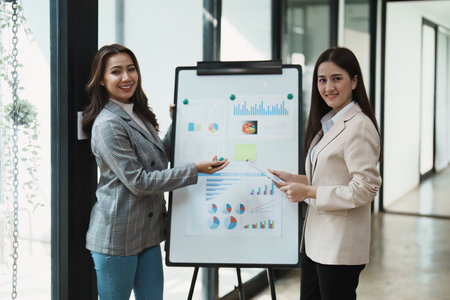 Financial analysts analyzing business reports on planned investment projects during corporate meeting discussions showcase successful teamwork with marketing plan.の写真素材