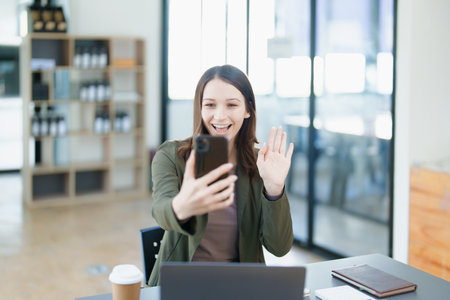 business owner or Asian female marketers are using business phones in office work.の写真素材
