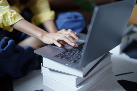 Portrait of a beautiful Asian teenage girl using a computer.の写真素材