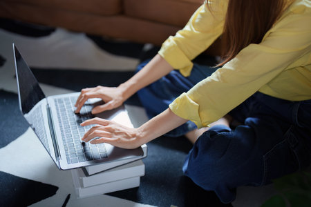 Portrait of a beautiful Asian teenage girl using a computer.の写真素材