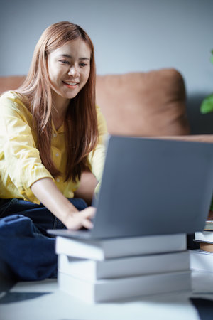 Portrait of a beautiful Asian teenage girl using a computer.