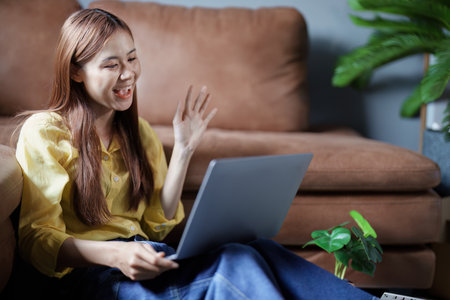 Portrait of a beautiful Asian teenage girl using a computer.の写真素材