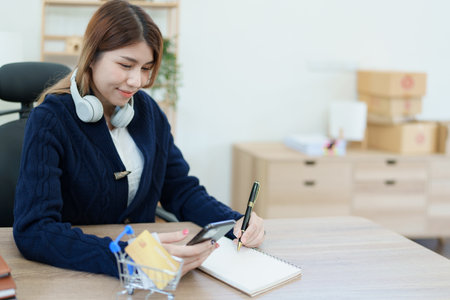 Online Shopping and Internet Payments, Asian man are using their credit card and mobile phone to shop online or conduct errands in the digital worldの写真素材