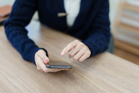 business owner or Asian female marketers are using business phones in office work.の写真素材