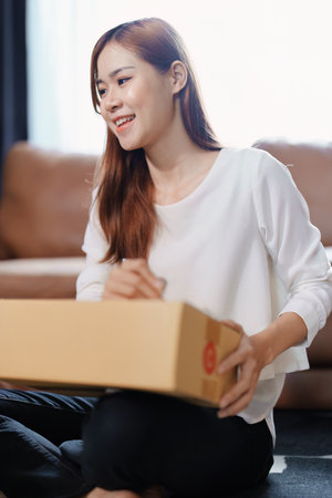 Starting small business entrepreneur of independent Asian female online seller packing products to send to customers and SME delivery concept.の写真素材