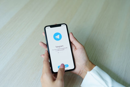 CHIANG MAI, THAILAND - Sep 08, 2022 - Telegram application icon on Apple iPhone Xs screen close-up. Telegram app icon. Telegram is an online social media network. Social media app.のeditorial素材