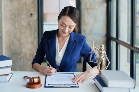 Law, Consultation, Agreement, Contract, Attorney or Lawyer holding a pen is consulting with a client to explain the pattern of answering questions before going to court to decide a lawsuitの写真素材