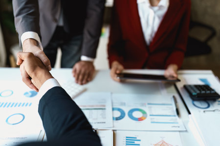 Asian entrepreneurs handshakes to congratulate the agreement between the two companies to enhance investment and financial strength. deal concept.の写真素材