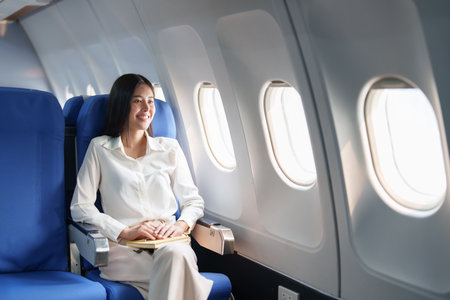 Asian attractive business woman passenger sitting on business class luxury plane while relax while travel concept.の写真素材