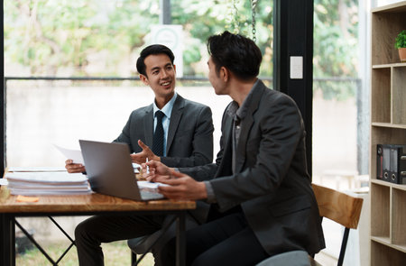 Asian business advisor meeting to analyze and discuss the situation on the financial report in the meeting room.Investment Consultant, Financial , teamwork ,brainstorming ,startup and accounting.の写真素材