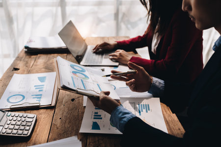 startup business, business advisor explaining strategy for planning finance investment teamwork paperwork audit and discussing marketing, profit, budget of company in meeting roomの写真素材